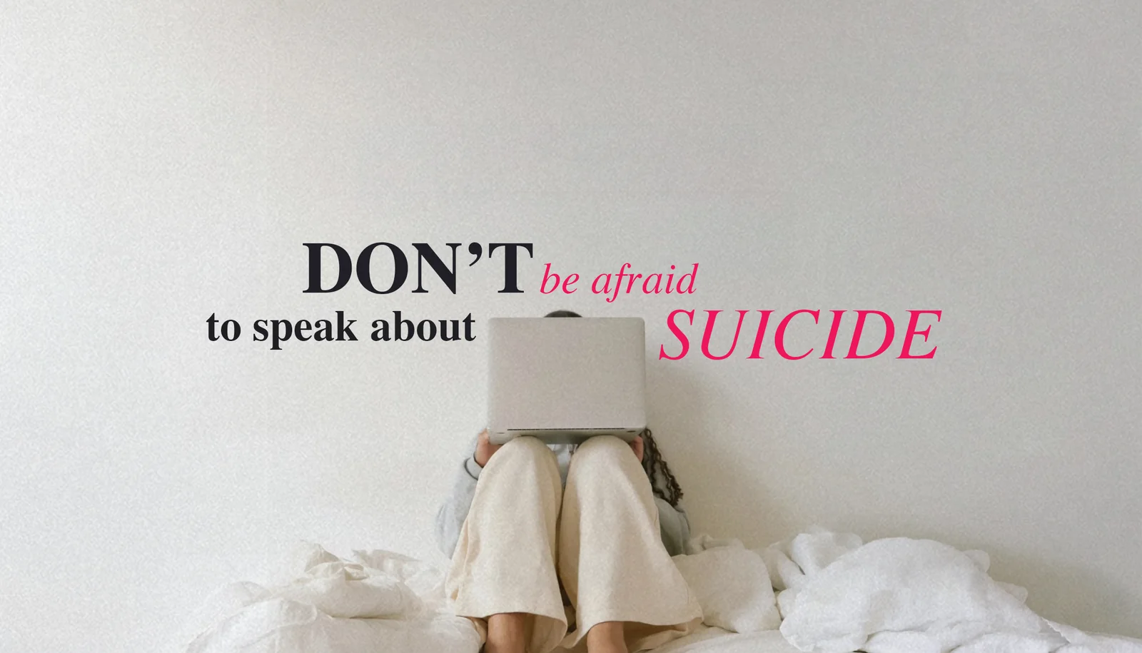 A person sitting on a bed with their face hidden behind an open laptop, beneath the words: Don&rsquo;t be afraid to speak about suicide